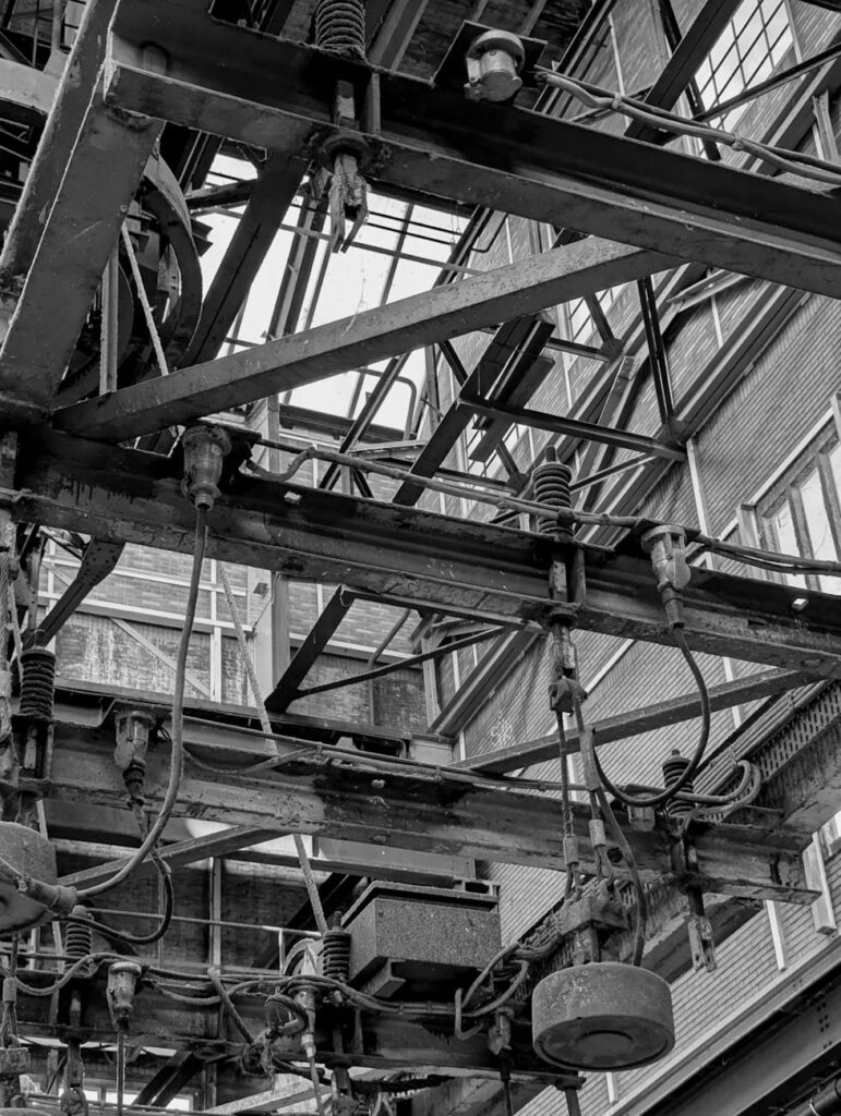 Black and white photo of intricate industrial machinery in Amsterdam.